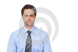 Zen businessman meditating with eyes closed