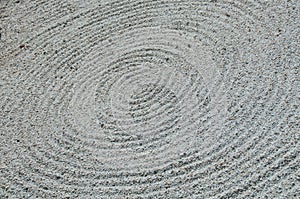Zen circle shape white sand rock garden floor