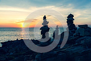 Zen concept. The object of the stones on the rock at sunset. Zen stones