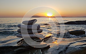 Zen concept. Pebble balance on the beach at sunset. Harmony & Meditation. Zen stones