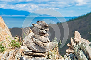 Zen concept. A pyramid made of stone on top of a mountain against the backdrop of Lake Baikal