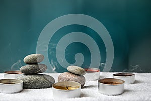 Zen concept, spa pebbles stones and burning aroma candles smoke, Treatment aromatherapy and massage copy space