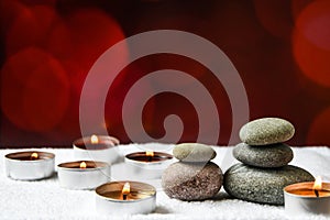 Zen concept, spa pebbles stones and burning aroma candles, Treatment aromatherapy and massage copy space