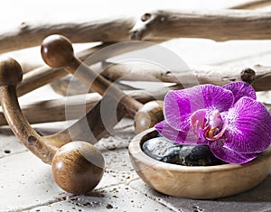 Zen femininity with orchid flowers and massage stones