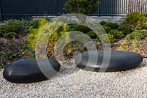 Zen garden dry landscape, or karesansui, japanese rock garden with black stones on white gravel for relaxation and