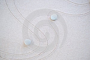 Zen Garden Japanese pattern on white sand background.