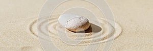 Zen garden meditation sandy background with stone cairn and lines on sand. Relaxation balance and harmony