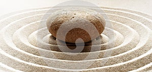 Zen garden meditation stone background with stones and lines in sand for relaxation balance and harmony spirituality or spa