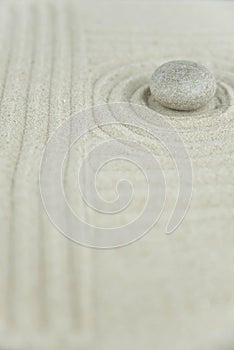 Zen garden. Pyramids of white and gray zen stones on the white sand with abstract wave drawings. Concept of harmony, balance and m