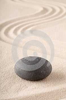 Zen garden with raked sand and round meditation stone for concentration and focus