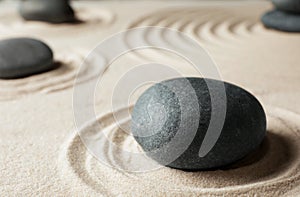 Zen garden stones on sand with pattern.