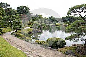 Zen lake with bonsai trees in Tokyo garden photo