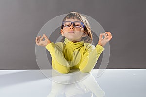 Zen little yoga child breathing, practicing yoga and closing eyes