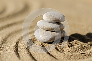 zen meditation stone in sand, concept for purity harmony and spirituality, spa wellness and yoga background