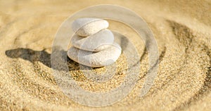 zen meditation stone in sand, concept for purity harmony and spirituality, spa wellness and yoga background