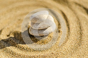 zen meditation stone in sand, concept for purity harmony and spirituality, spa wellness and yoga background