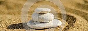 zen meditation stone in sand, concept for purity harmony and spirituality, spa wellness and yoga background