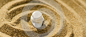 zen meditation stone in sand, concept for purity harmony and spirituality, spa wellness and yoga background