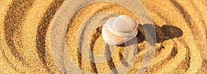 zen meditation stone in sand, concept for purity harmony and spirituality, spa wellness and yoga background