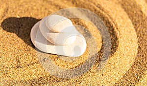 zen meditation stone in sand, concept for purity harmony and spirituality, spa wellness and yoga background