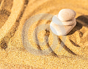 zen meditation stone in sand, concept for purity harmony and spirituality, spa wellness and yoga background