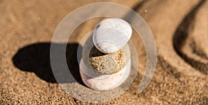 zen meditation stone in sand, concept for purity harmony and spirituality, spa wellness and yoga background