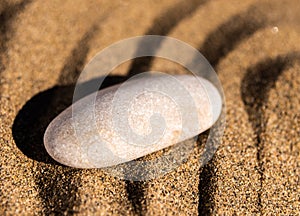 zen meditation stone in sand, concept for purity harmony and spirituality, spa wellness and yoga background