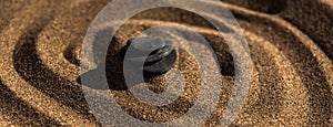 zen meditation stone in sand, concept for purity harmony and spirituality, spa wellness and yoga background