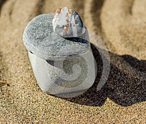 zen meditation stone in sand, concept for purity harmony and spirituality, spa wellness and yoga background