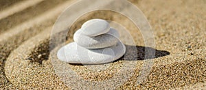 zen meditation stone in sand, concept for purity harmony and spirituality, spa wellness and yoga background