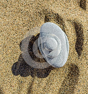 zen meditation stone in sand, concept for purity harmony and spirituality, spa wellness and yoga background