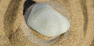 zen meditation stone in sand, concept for purity harmony and spirituality, spa wellness and yoga background