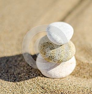 zen meditation stone in sand, concept for purity harmony and spirituality, spa wellness and yoga background