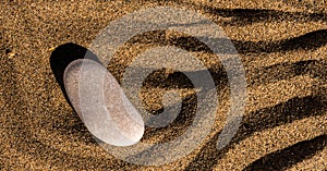 zen meditation stone in sand, concept for purity harmony and spirituality, spa wellness and yoga background