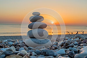 Zen pebbles standing on the beach at sunset