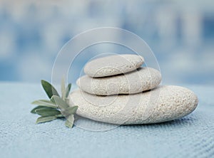 Zen pyramid of spa stones on the blurred sea background. Sand on a beach. Sea shores. Water waves texture. Left side of photo. Pla