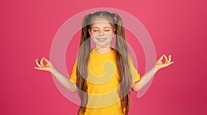 Zen. Relaxed Little Girl Meditating With Closed Eyes Over Pink Background