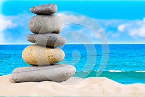 Zen rock, concept of harmony and balance. Zen stones pyramid on the beach with amazing turquoise blue water sea and sky