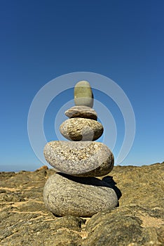 Zen rock stack on Pacific Ocean coast with waves on shore