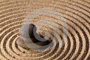 Zen stacked stones on sand in natural light photo