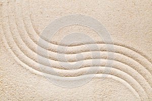 Zen sand and stone garden with raked lines, curves and circles.