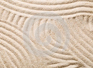 Zen sand and stone garden with raked lines, curves and circles.