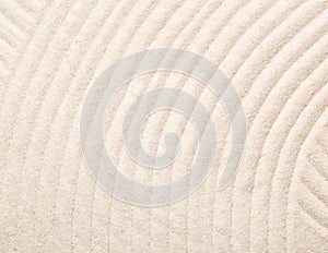 Zen sand and stone garden with raked lines, curves and circles.