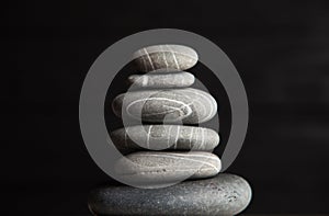 Zen sculpture. Harmony and balance, cairn, poise stones on wooden table