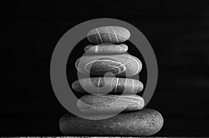 Zen sculpture. Harmony and balance, cairn, poise stones on wooden table