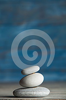 Zen sculpture. Harmony and balance, cairn, poise stones on wooden table