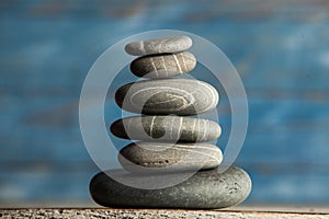 Zen sculpture. Harmony and balance, cairn, poise stones on wooden table