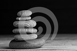 Zen sculpture. Harmony and balance, cairn, poise stones on wooden table