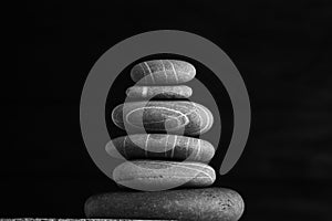 Zen sculpture. Harmony and balance, cairn, poise stones on wooden table