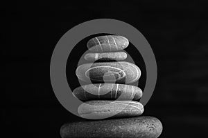 Zen sculpture. Harmony and balance, cairn, poise stones on wooden table